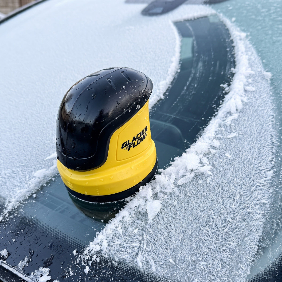 GlacierFlow electric ice scraper clearing frost from a windshield